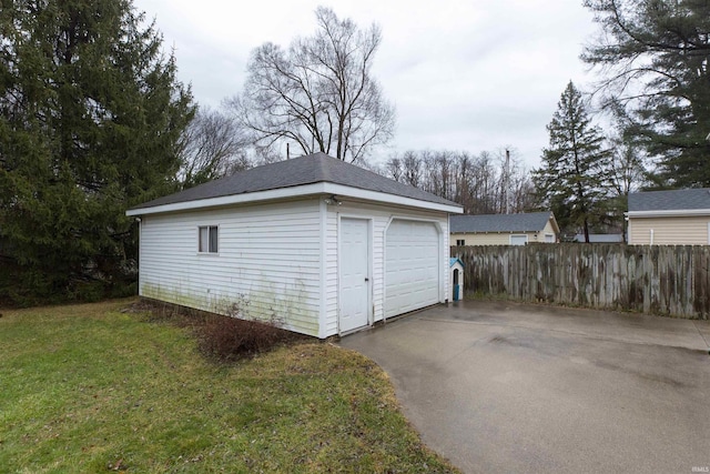 detached garage featuring fence