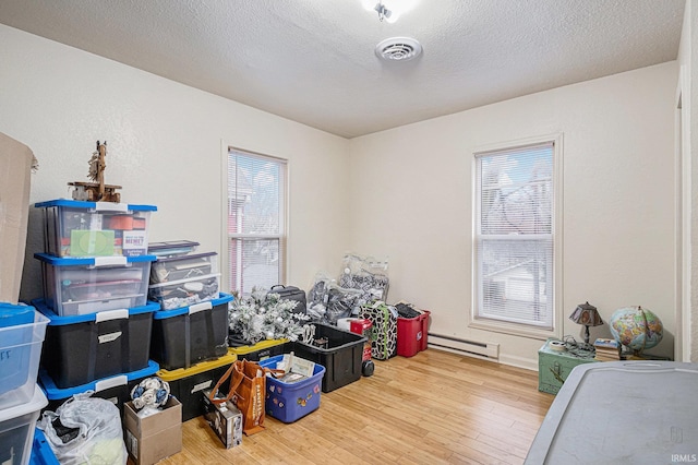 storage featuring a baseboard radiator and visible vents