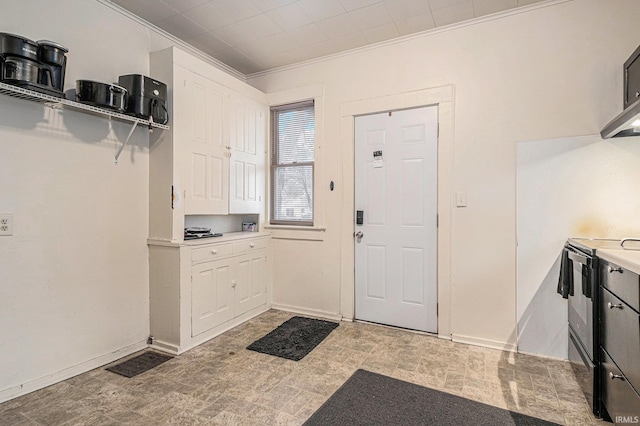 interior space with baseboards, visible vents, ornamental molding, and light countertops