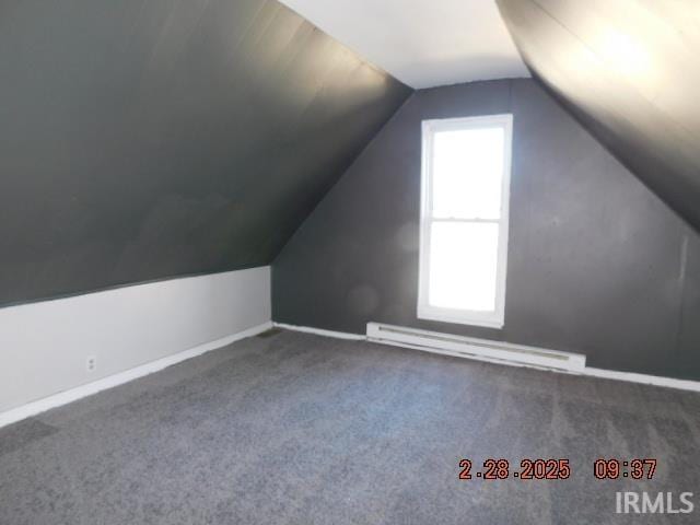 bonus room featuring vaulted ceiling, a baseboard radiator, carpet flooring, and baseboards