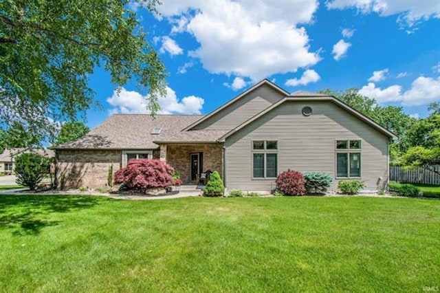 view of front of house with fence and a front yard