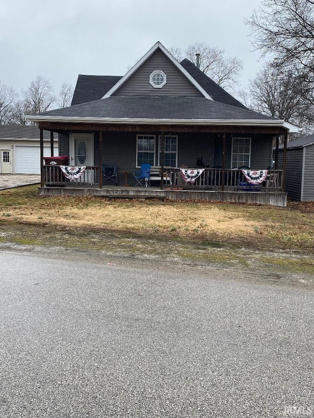 farmhouse with a garage and a porch