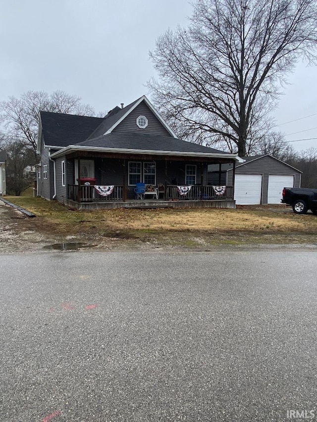 view of front facade with a porch, an outdoor structure, and a garage