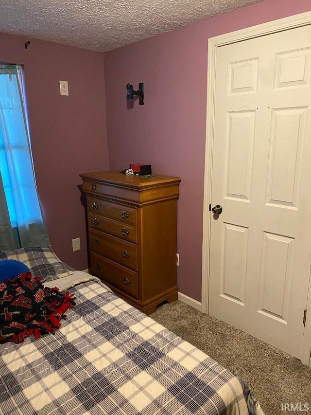 unfurnished bedroom with a textured ceiling and carpet