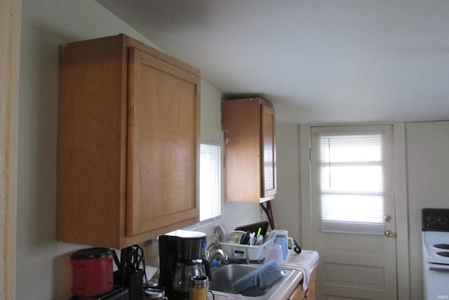 kitchen with plenty of natural light, electric range, and a sink