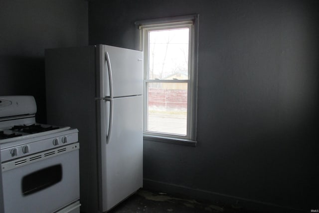 kitchen with white appliances and baseboards