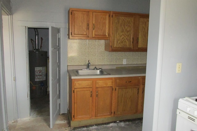 kitchen with brown cabinetry, gas water heater, a sink, and backsplash