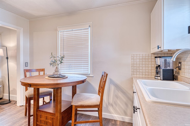 dining space featuring light wood finished floors and baseboards