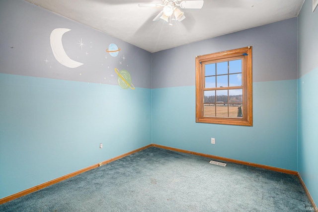 carpeted empty room featuring ceiling fan, visible vents, and baseboards