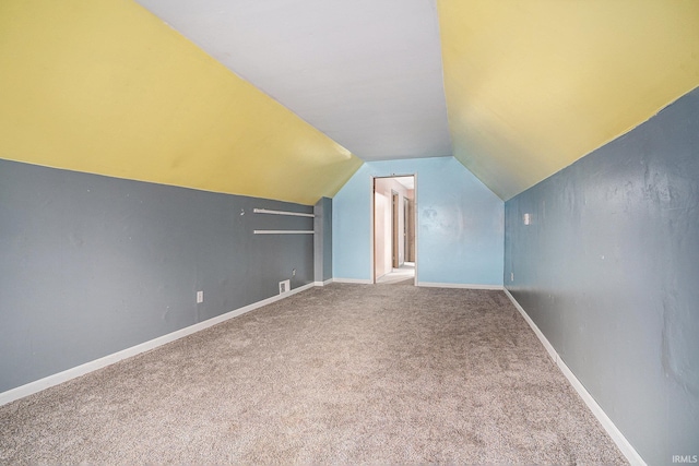 bonus room with lofted ceiling, carpet floors, visible vents, and baseboards