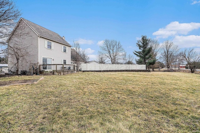 view of yard featuring fence and a deck