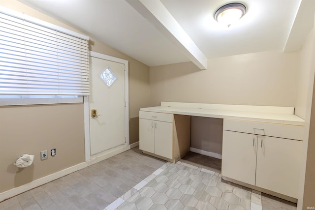 clothes washing area featuring baseboards