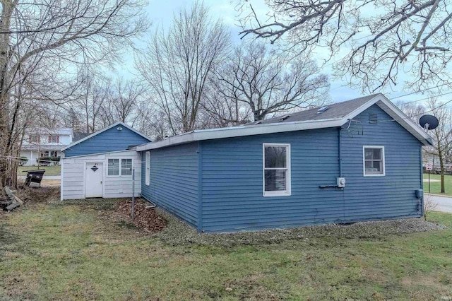 rear view of property featuring a yard