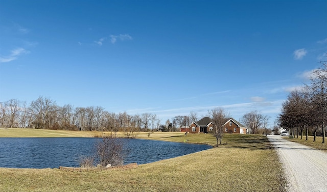 exterior space with gravel driveway and a water view