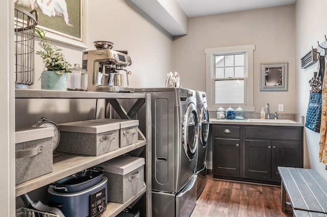 laundry room with cabinet space, dark wood-style flooring, a sink, and washing machine and clothes dryer