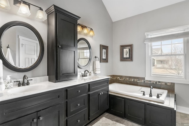 full bathroom featuring plenty of natural light, a sink, and lofted ceiling