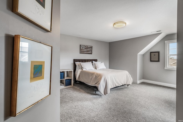 bedroom with carpet floors, baseboards, and visible vents