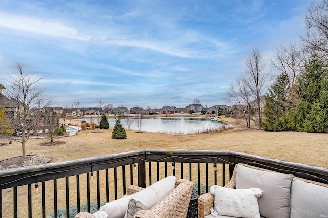 wooden deck featuring a residential view and a water view