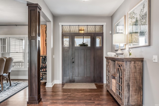 entrance foyer featuring dark wood finished floors and baseboards