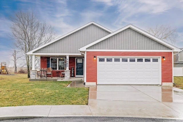 view of front of house featuring a porch, a garage, a front lawn, and concrete driveway