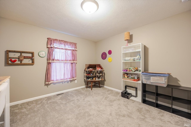 interior space with carpet, baseboards, and a textured ceiling