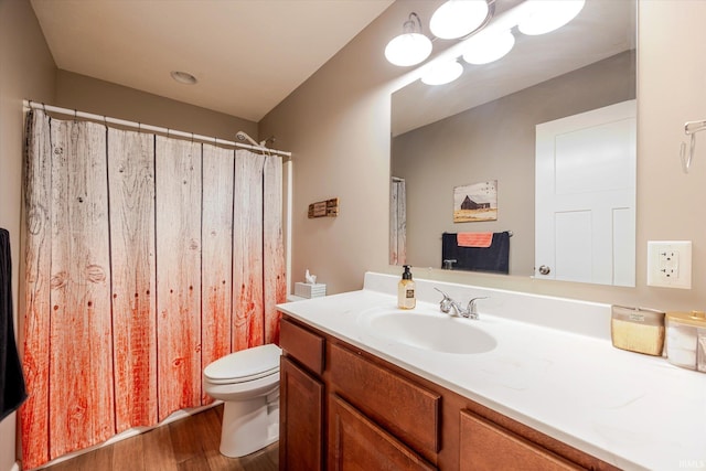 full bath featuring a shower with shower curtain, vanity, toilet, and wood finished floors