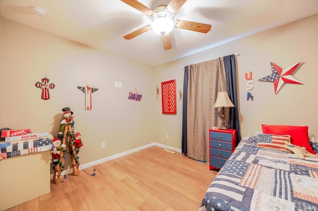 bedroom featuring baseboards, ceiling fan, and light wood-style floors