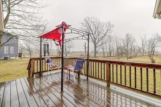 wooden terrace with a yard and central air condition unit