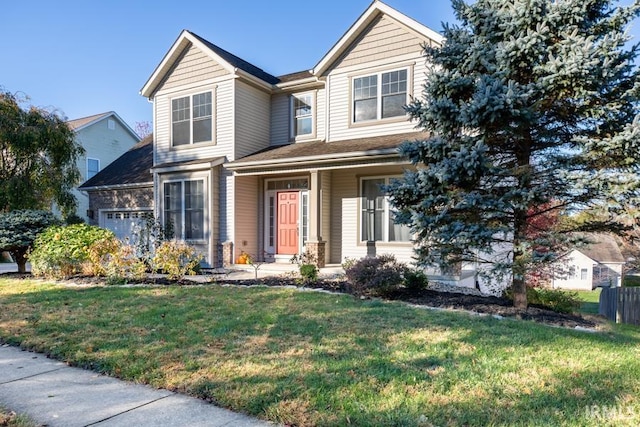 view of front of home with an attached garage and a front lawn