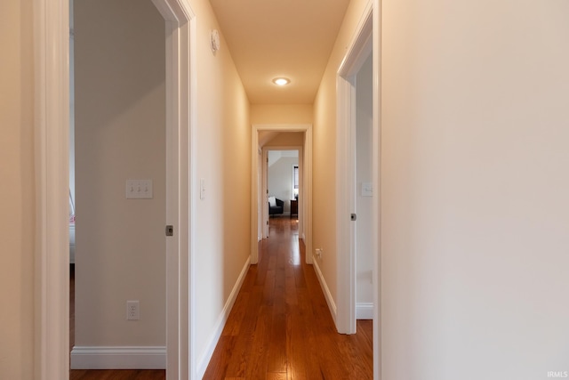 hall with wood finished floors and baseboards