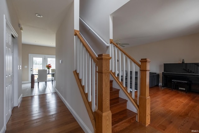 staircase featuring hardwood / wood-style floors and baseboards