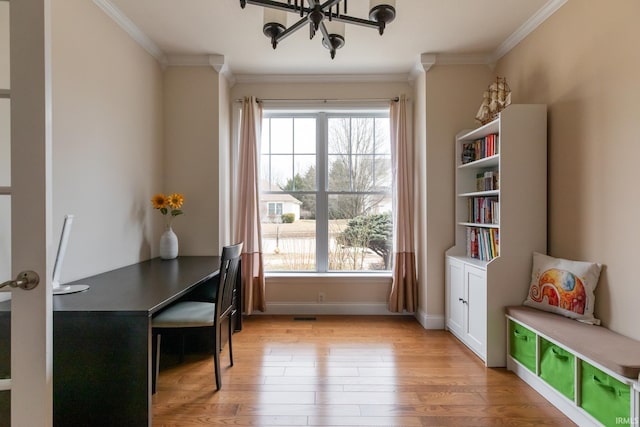 office space featuring baseboards, light wood-type flooring, visible vents, and crown molding