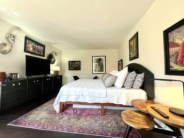 bedroom featuring a textured ceiling and wood finished floors