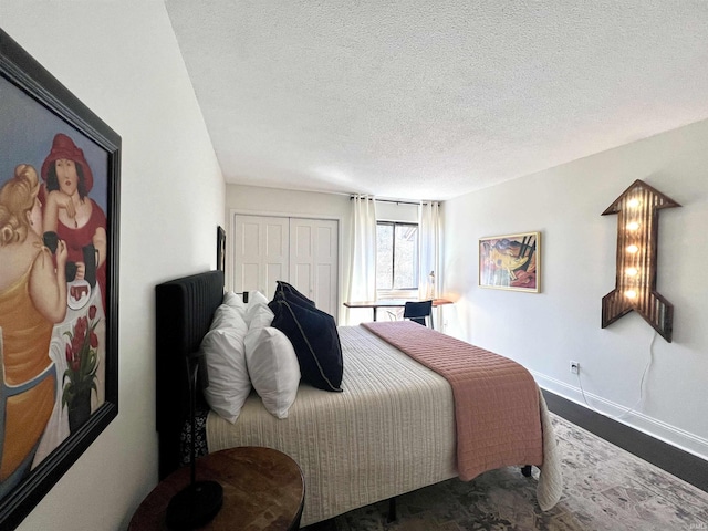 bedroom with a closet, baseboards, and a textured ceiling