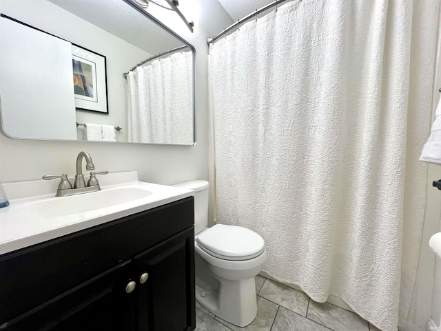 full bath featuring vanity and toilet