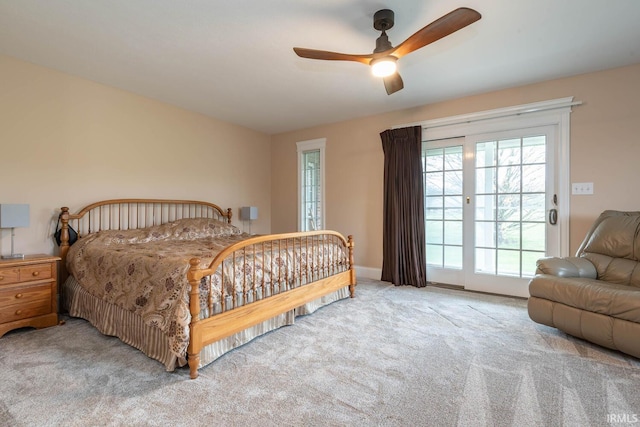 carpeted bedroom featuring access to outside, baseboards, and a ceiling fan