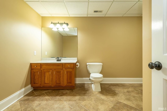 half bath with toilet, baseboards, visible vents, and vanity