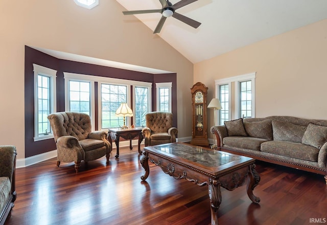 living room featuring high vaulted ceiling, a ceiling fan, baseboards, and wood finished floors