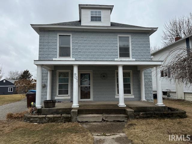 traditional style home featuring a porch