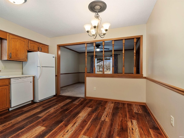 kitchen with white appliances, brown cabinets, and dark wood-style flooring