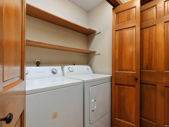 clothes washing area with laundry area and washer and clothes dryer