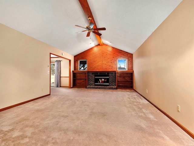 unfurnished living room featuring a brick fireplace, beam ceiling, carpet flooring, and baseboards