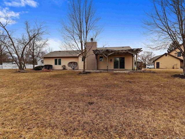 ranch-style home featuring a front yard and a chimney