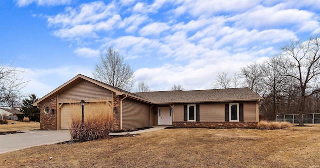 ranch-style house with driveway, brick siding, an attached garage, and fence