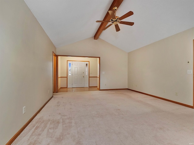 empty room featuring light carpet, ceiling fan, lofted ceiling with beams, and baseboards