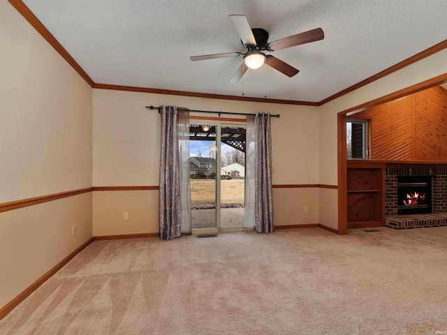 unfurnished living room with a textured ceiling, crown molding, a fireplace, and carpet flooring