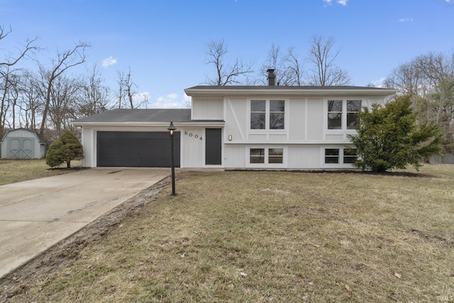 split level home featuring driveway, an outbuilding, an attached garage, a shed, and a front lawn