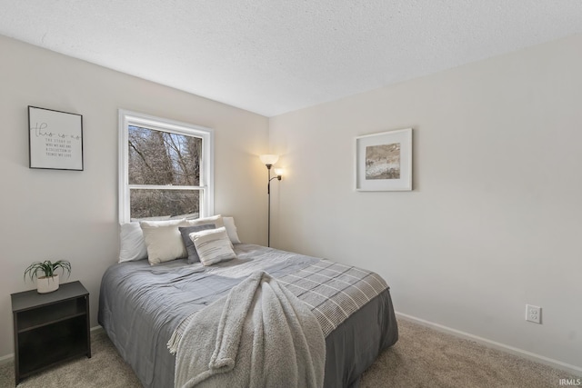 carpeted bedroom with baseboards and a textured ceiling