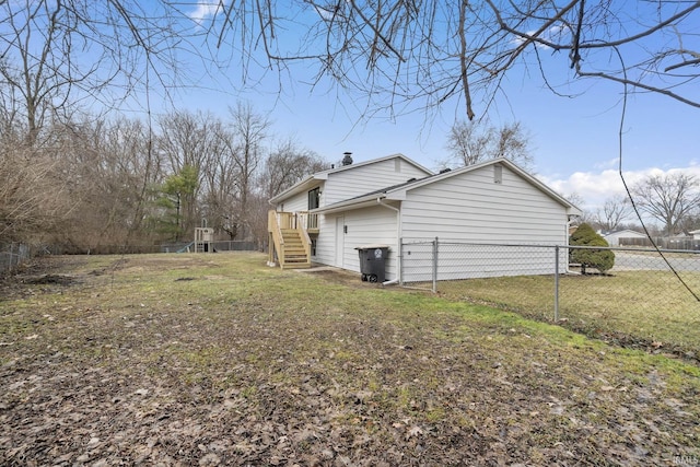 view of side of property with a chimney, fence, and a lawn