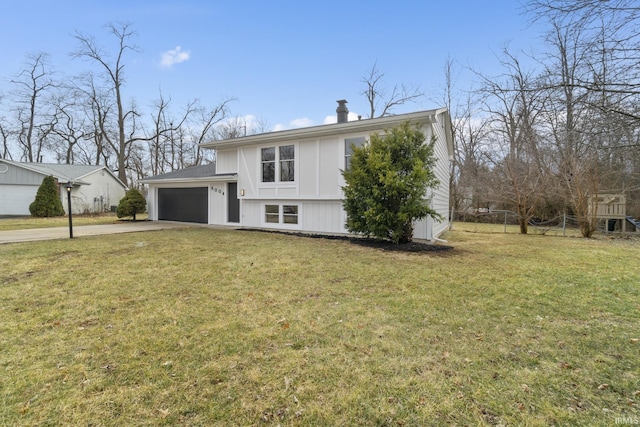 view of front of home with a garage, driveway, and a front lawn